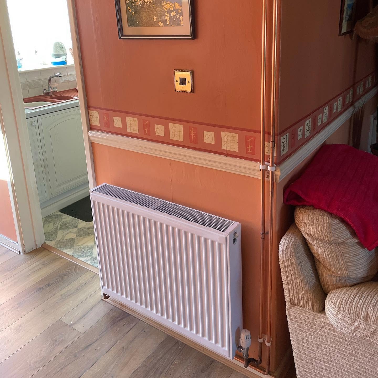 Central heating installation in Basingstoke with a new radiator and thermostatic valve