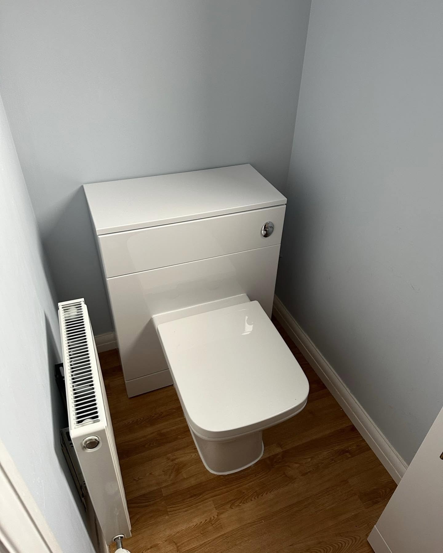 Modern close-coupled toilet installed in a cloakroom plumbing project