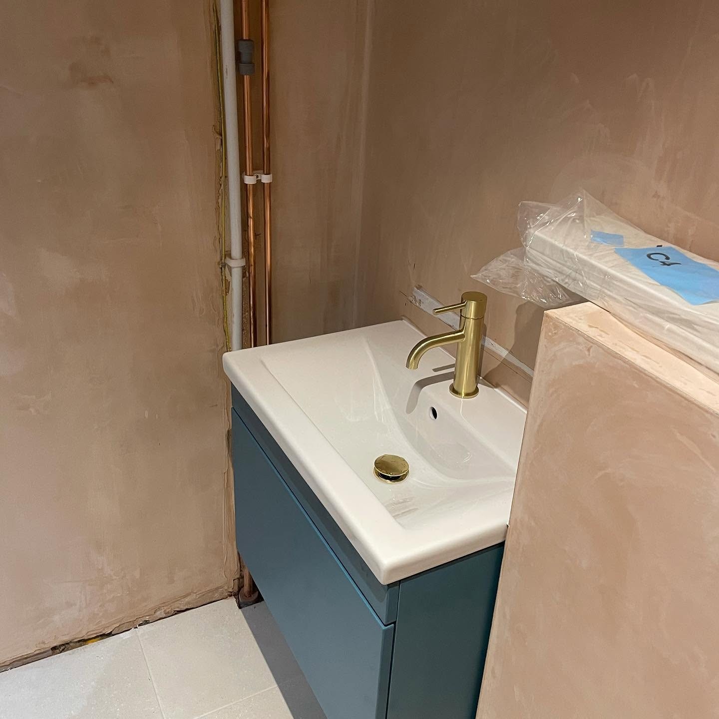 Cloakroom vanity unit and brass mixer tap fitted and connected