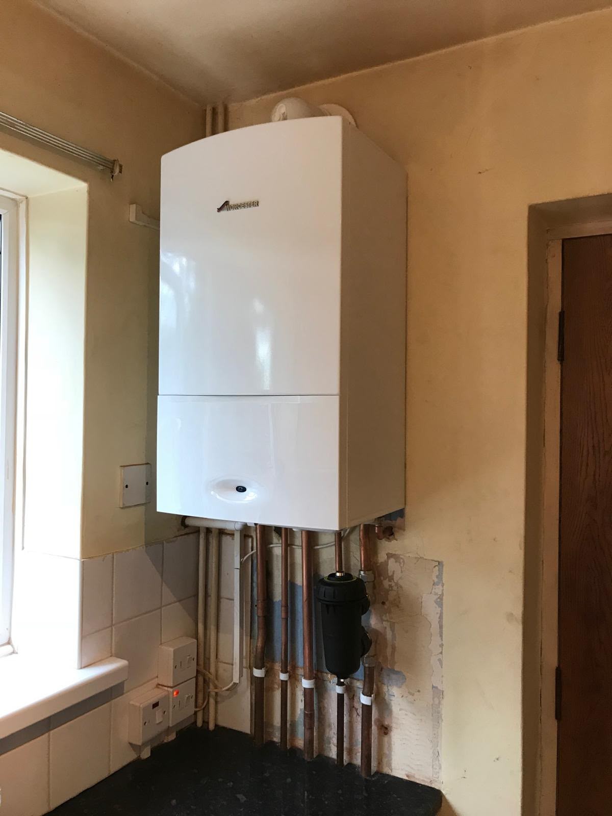 Gas boiler installed in an airing cupboard with tidy copper connections