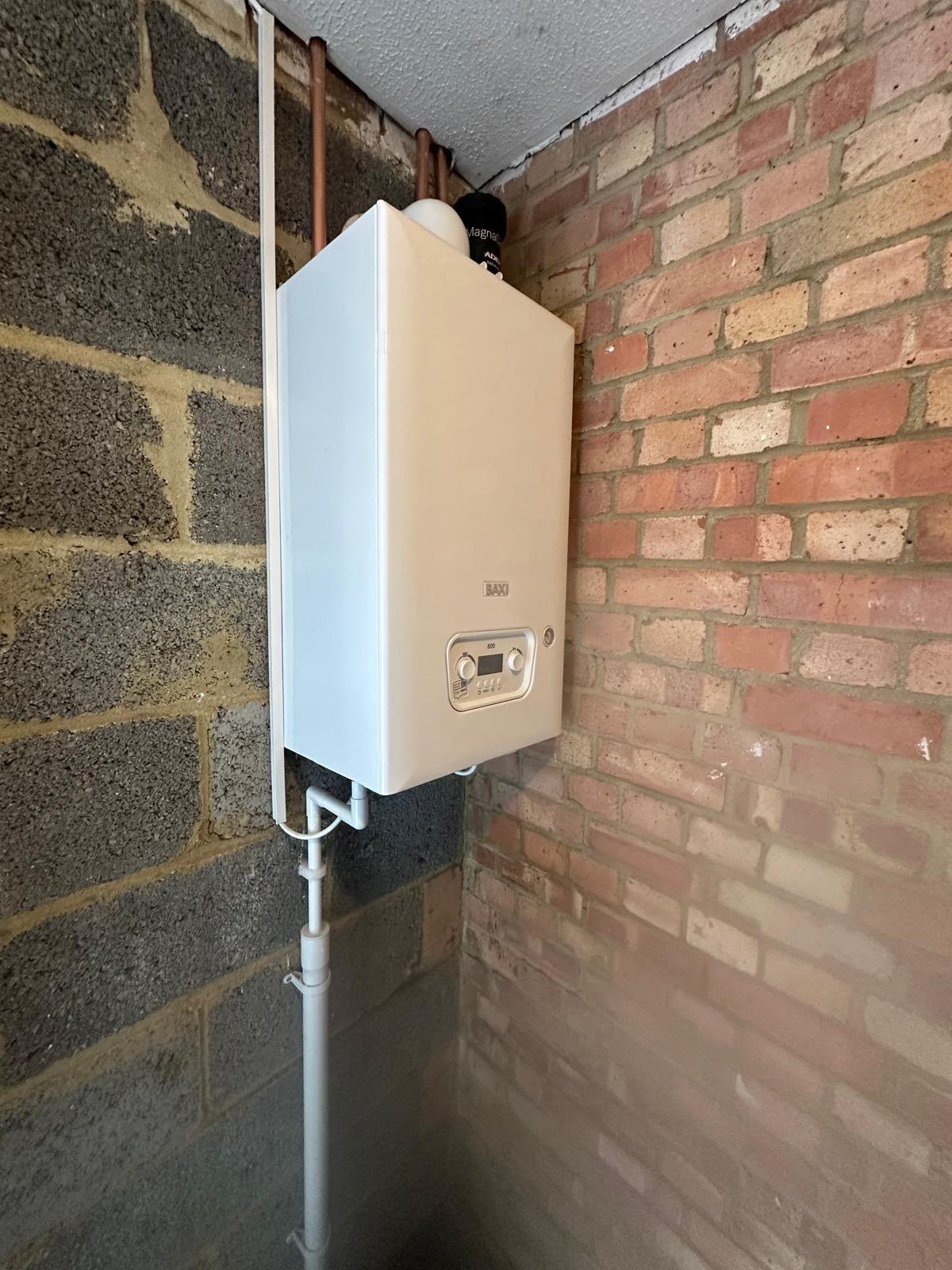 Wall-hung gas boiler installation completed in a domestic kitchen