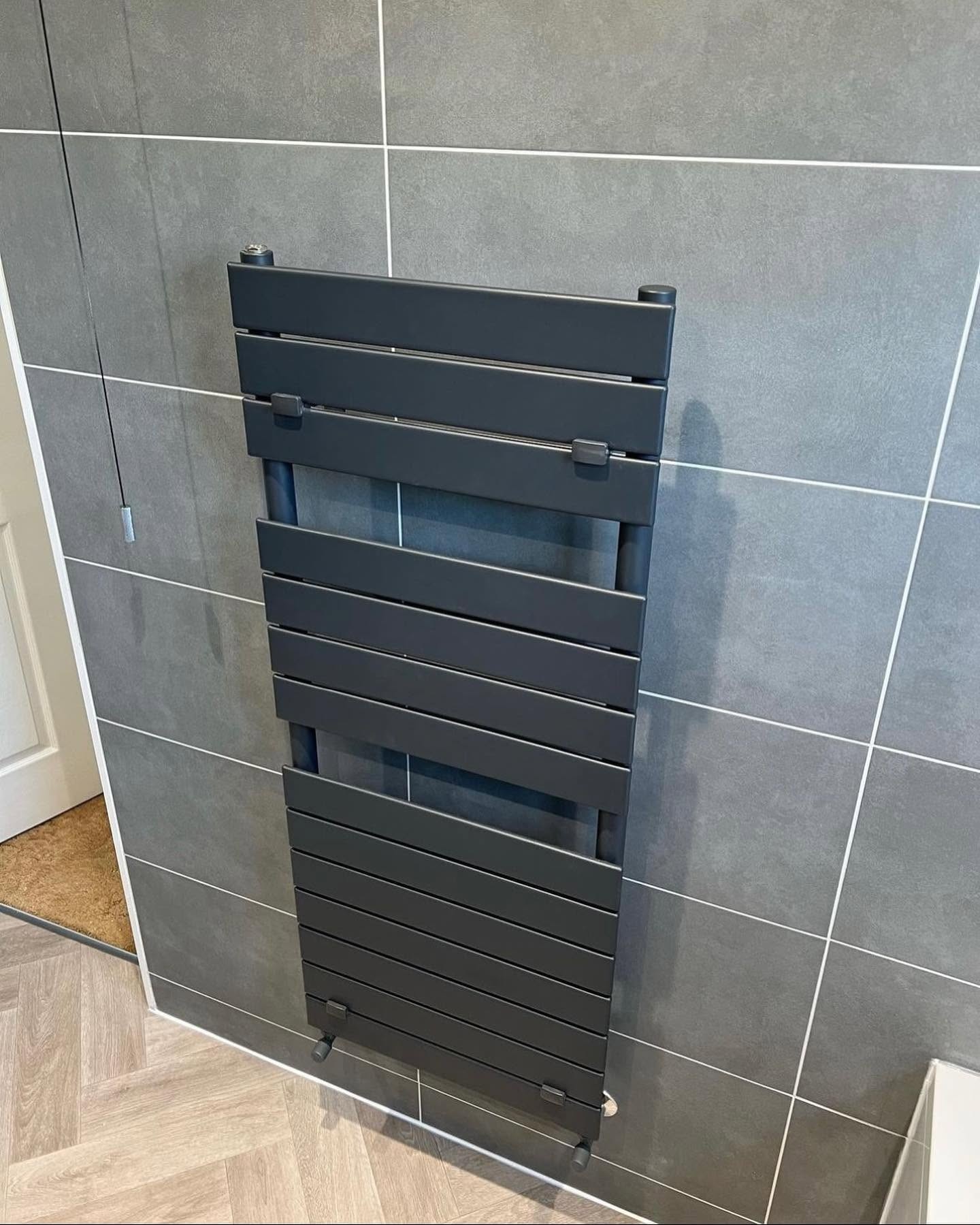 Anthracite flat panel radiator fitted during a central heating installation