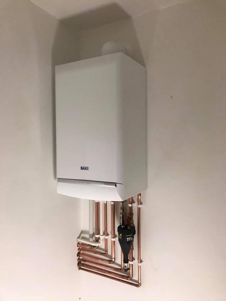 Replacement gas boiler installation with insulated flow and return pipework